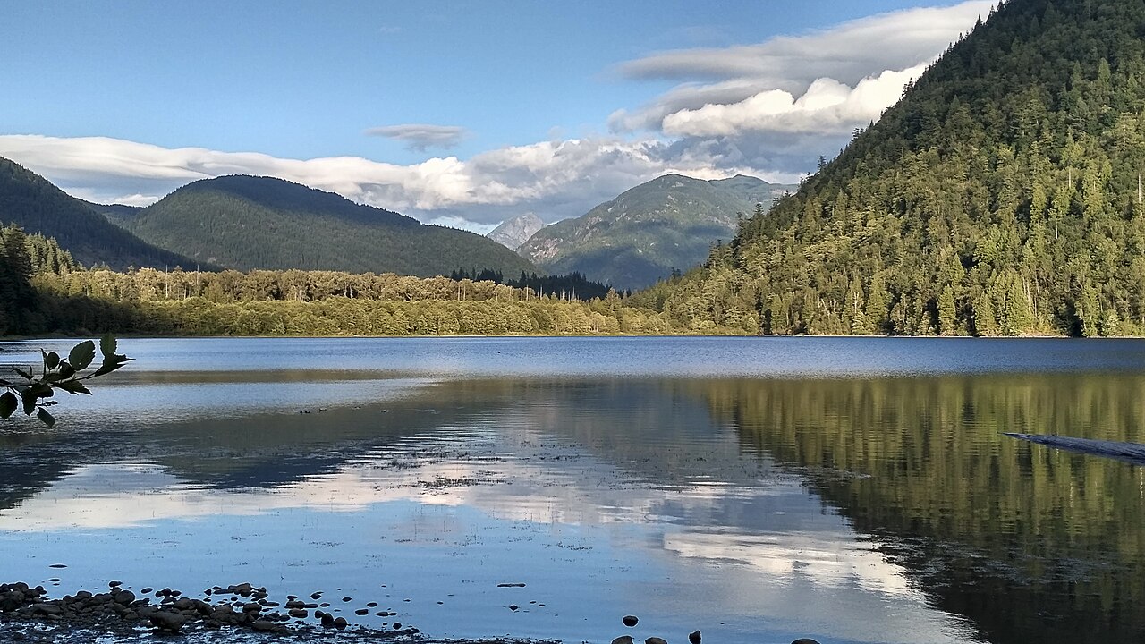 Forested slopes reflected in Deer Lake at Sasquatch Provincial Park