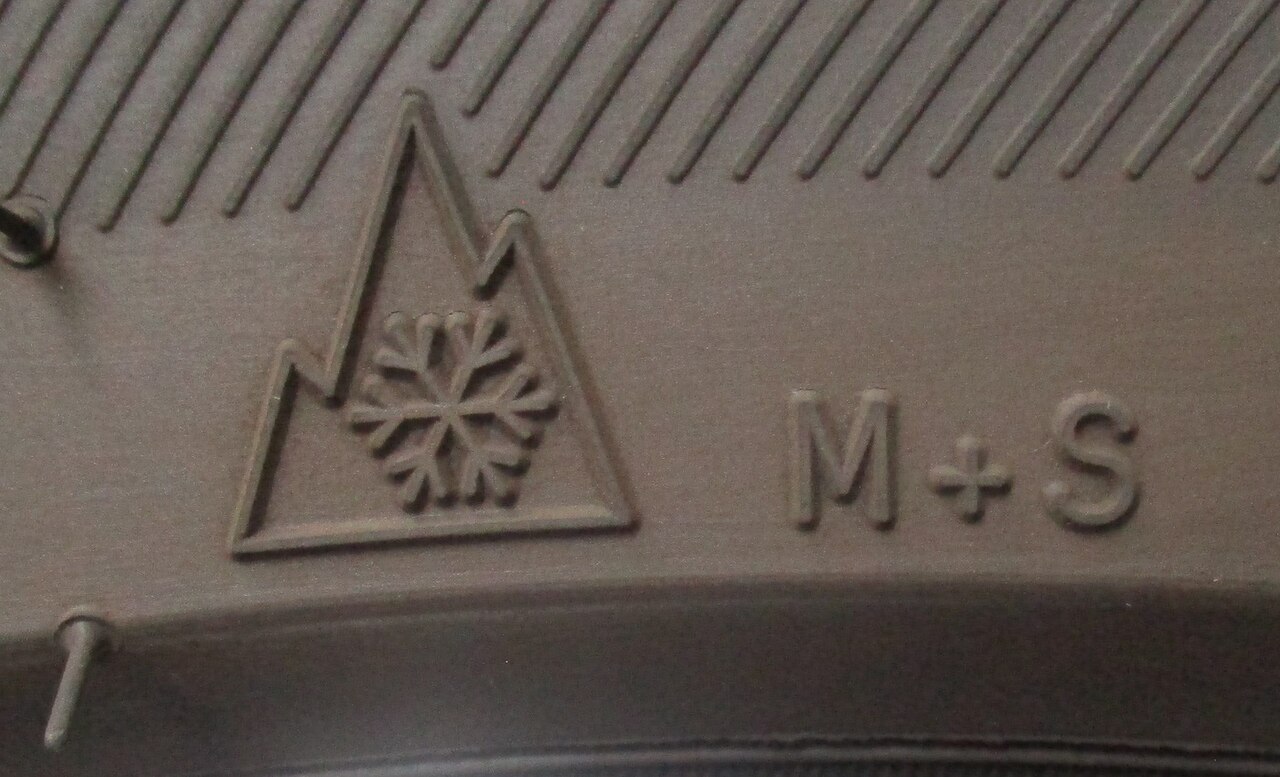 Mountain-and-snowflake and M+S markings on a tire sidewall